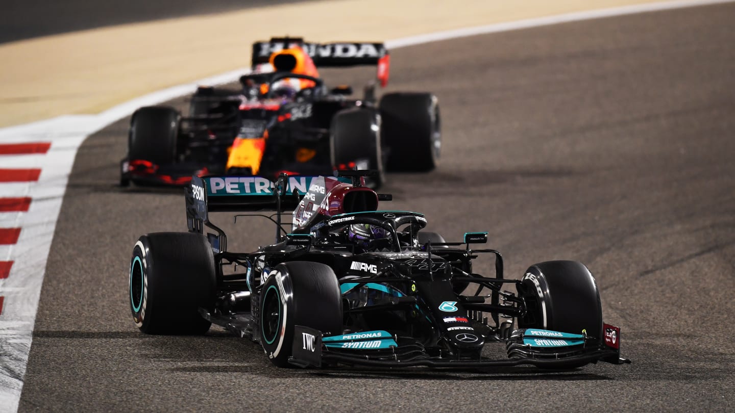 BAHRAIN, BAHRAIN - MARCH 28: Lewis Hamilton of Great Britain driving the (44) Mercedes AMG Petronas F1 Team Mercedes W12 leads Max Verstappen of the Netherlands driving the (33) Red Bull Racing RB16B Honda during the F1 Grand Prix of Bahrain at Bahrain International Circuit on March 28, 2021 in Bahrain, Bahrain. (Photo by Clive Mason - Formula 1/Formula 1 via Getty Images)