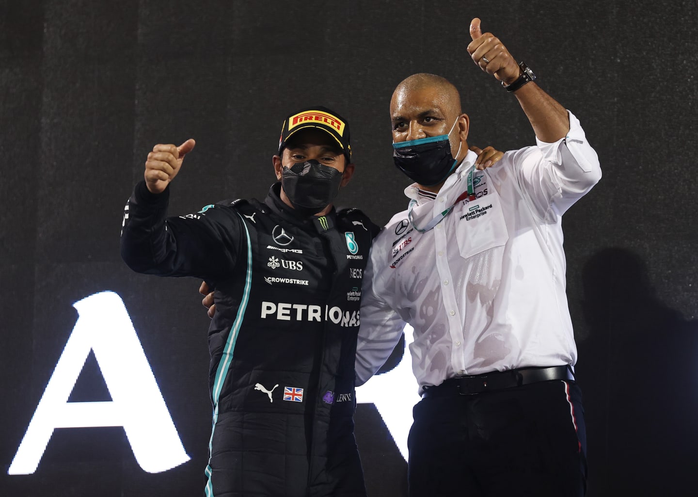 BAHRAIN, BAHRAIN - MARCH 28: Race winner Lewis Hamilton of Great Britain and Mercedes GP and Russell Braithwaite, Chief Financial Officer of Mercedes GP, celebrate on the podium during the F1 Grand Prix of Bahrain at Bahrain International Circuit on March 28, 2021 in Bahrain, Bahrain. (Photo by Lars Baron/Getty Images)