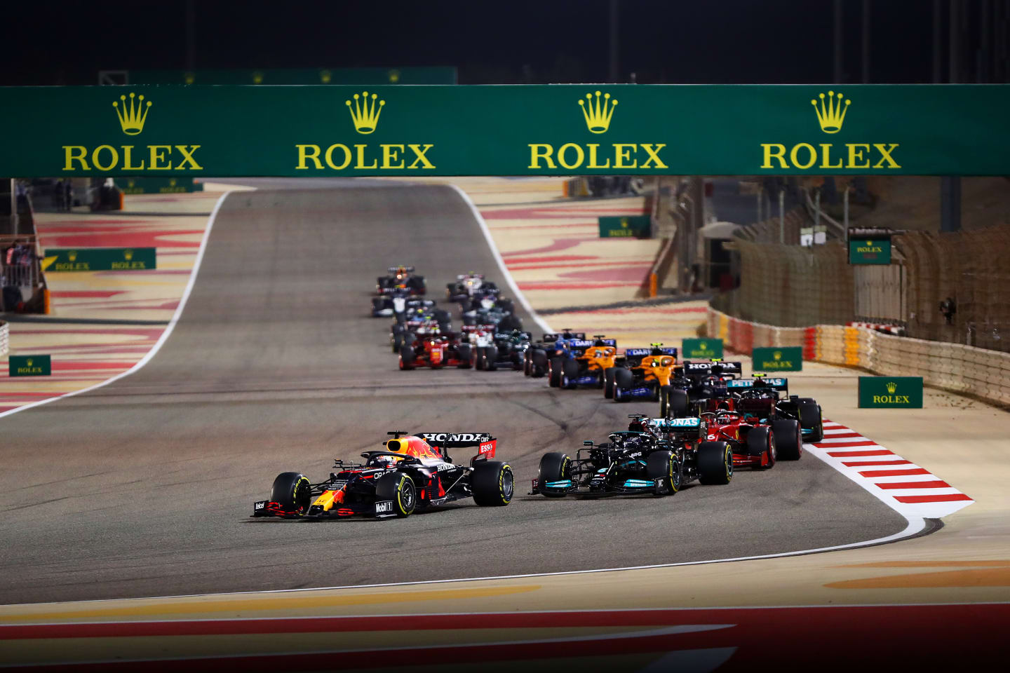 BAHRAIN, BAHRAIN - MARCH 28:  Max Verstappen of the Netherlands driving the (33) Red Bull Racing RB16B Honda leads Lewis Hamilton of Great Britain driving the (44) Mercedes AMG Petronas F1 Team Mercedes W12 and Charles Leclerc of Monaco driving the (16) Scuderia Ferrari SF21  during the F1 Grand Prix of Bahrain at Bahrain International Circuit on March 28, 2021 in Bahrain, Bahrain. (Photo by Dan Istitene - Formula 1/Formula 1 via Getty Images)