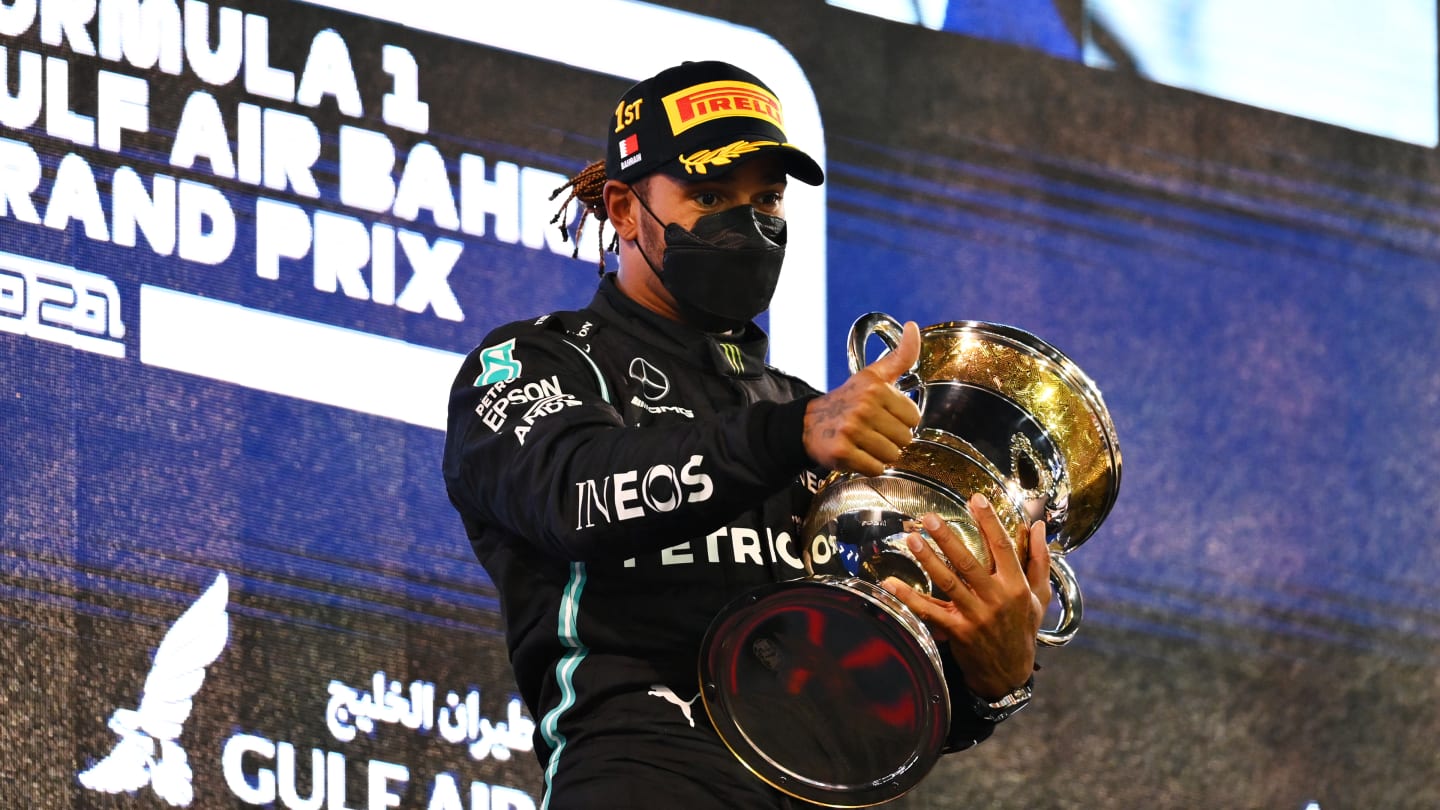 BAHRAIN, BAHRAIN - MARCH 28: Race winner Lewis Hamilton of Great Britain and Mercedes GP celebrates on the podium after the F1 Grand Prix of Bahrain at Bahrain International Circuit on March 28, 2021 in Bahrain, Bahrain. (Photo by Clive Mason - Formula 1/Formula 1 via Getty Images)