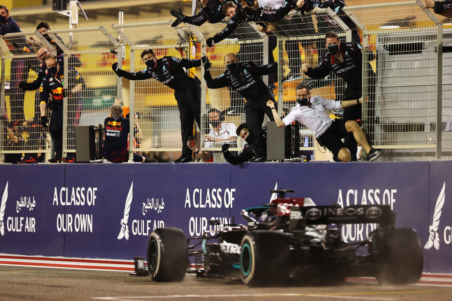 BAHRAIN, BAHRAIN - MARCH 28: Mercedes GP team members celebrate on the pitwall as Lewis Hamilton of