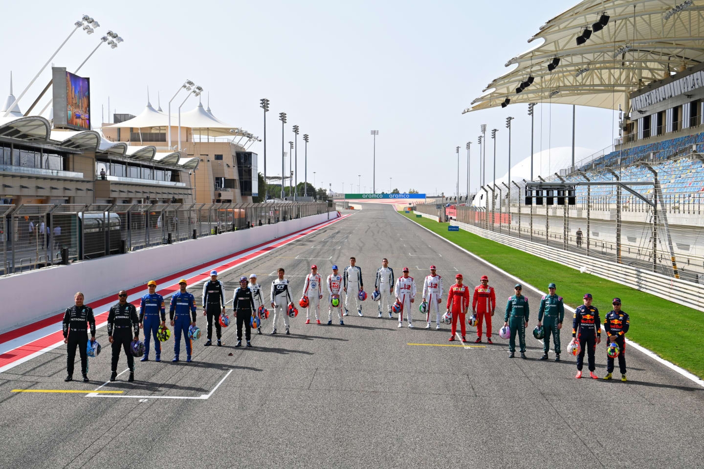 BAHRAIN, BAHRAIN - MARCH 12: The F1 drivers stand on the grid during Day One of F1 Testing at