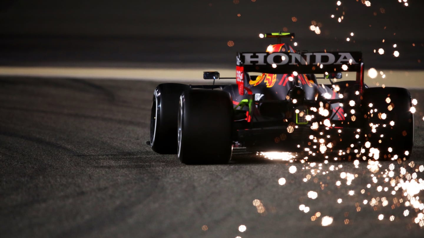 BAHRAIN, BAHRAIN - MARCH 13: Sparks fly behind Sergio Perez of Mexico driving the (11) Red Bull