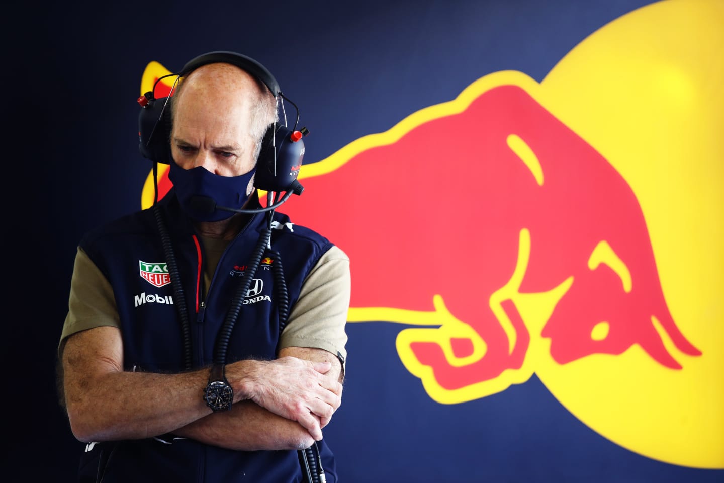 Red Bull's design master Adrian Newey watches on from the garage