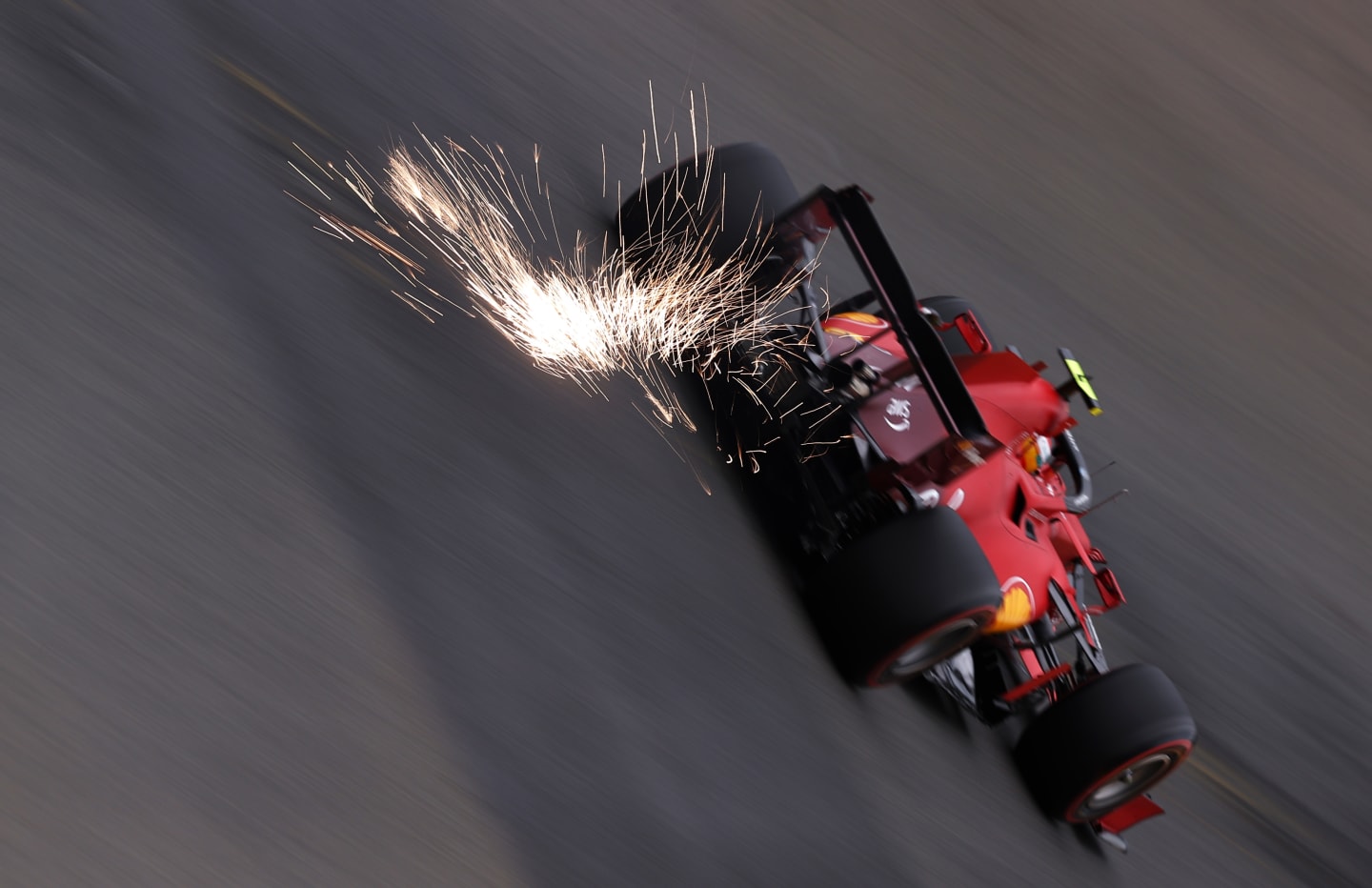SPA, BELGIUM - AUGUST 27: Sparks fly behind Carlos Sainz of Spain driving the (55) Scuderia Ferrari SF21 during practice ahead of the F1 Grand Prix of Belgium at Circuit de Spa-Francorchamps on August 27, 2021 in Spa, Belgium. (Photo by Lars Baron/Getty Images)