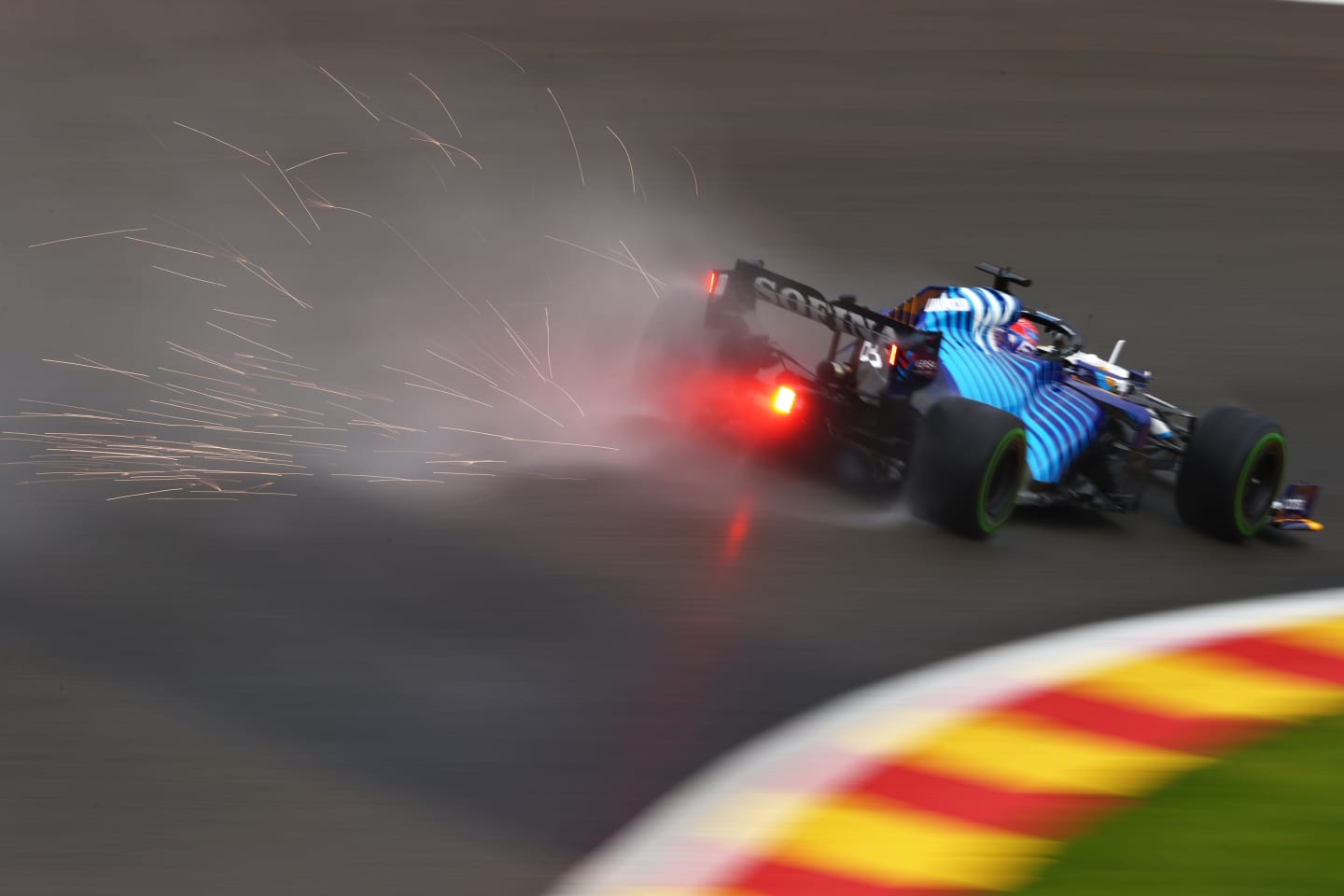SPA, BELGIUM - AUGUST 28: Sparks fly behind George Russell of Great Britain driving the (63) Williams Racing FW43B Mercedes during qualifying ahead of the F1 Grand Prix of Belgium at Circuit de Spa-Francorchamps on August 28, 2021 in Spa, Belgium. (Photo by Dan Istitene - Formula 1/Formula 1 via Getty Images)