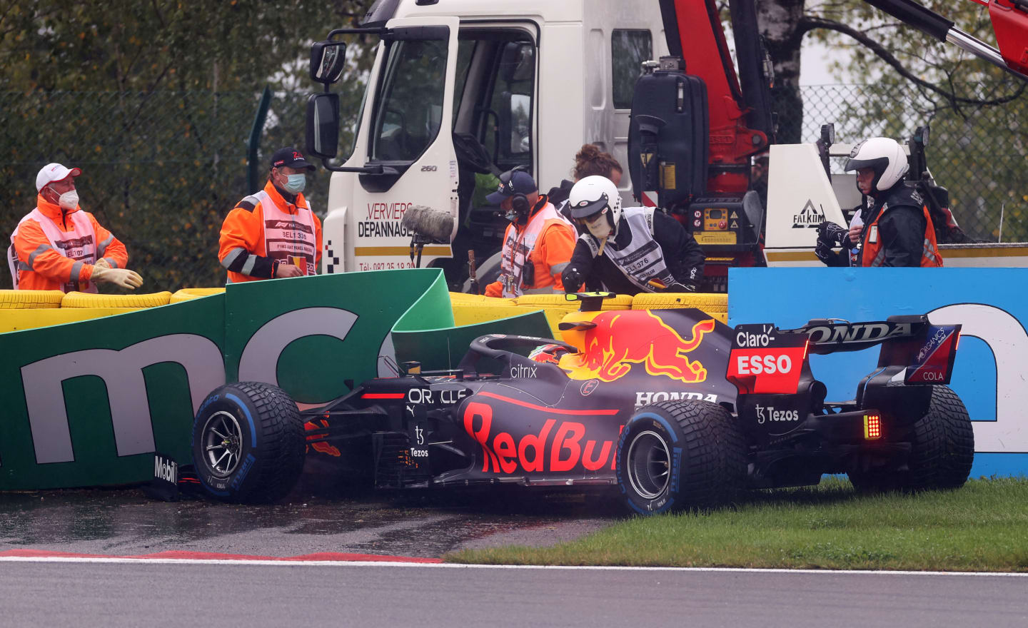 SPA, BELGIUM - AUGUST 29: Sergio Perez of Mexico driving the (11) Red Bull Racing RB16B Honda crashes on his way to the grid prior to the F1 Grand Prix of Belgium at Circuit de Spa-Francorchamps on August 29, 2021 in Spa, Belgium. (Photo by Lars Baron/Getty Images)