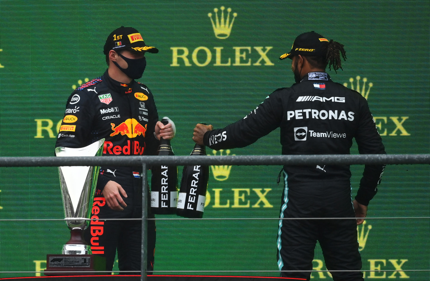 SPA, BELGIUM - AUGUST 29: Race winner Max Verstappen of Netherlands and Red Bull Racing and third placed Lewis Hamilton of Great Britain and Mercedes GP celebrate on the podium during the F1 Grand Prix of Belgium at Circuit de Spa-Francorchamps on August 29, 2021 in Spa, Belgium. (Photo by Dan Mullan/Getty Images)