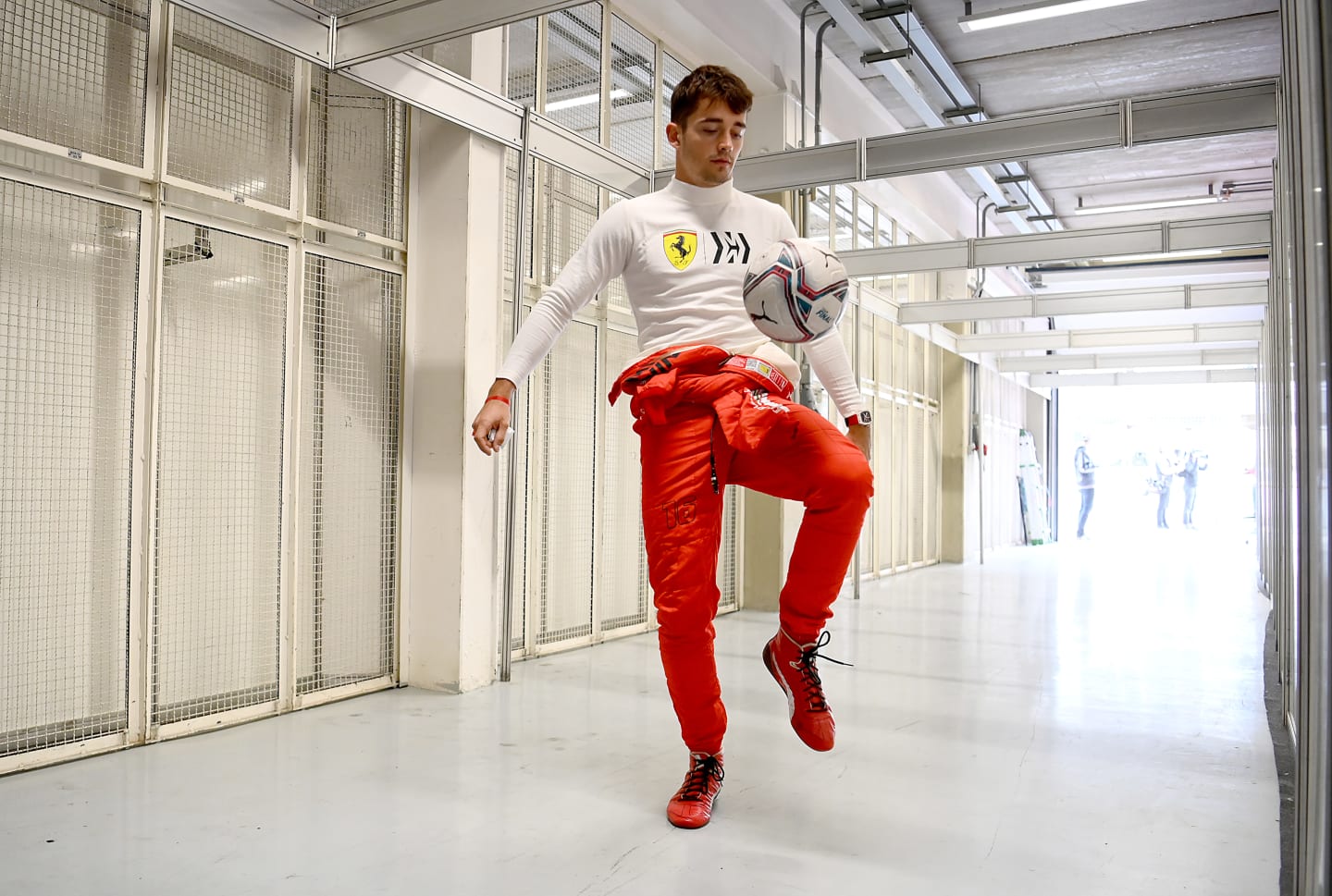 SAO PAULO, BRAZIL - NOVEMBER 12: Charles Leclerc of Monaco and Ferrari warms up by playing football during practice ahead of the F1 Grand Prix of Brazil at Autodromo Jose Carlos Pace on November 12, 2021 in Sao Paulo, Brazil. (Photo by Clive Mason - Formula 1/Formula 1 via Getty Images)