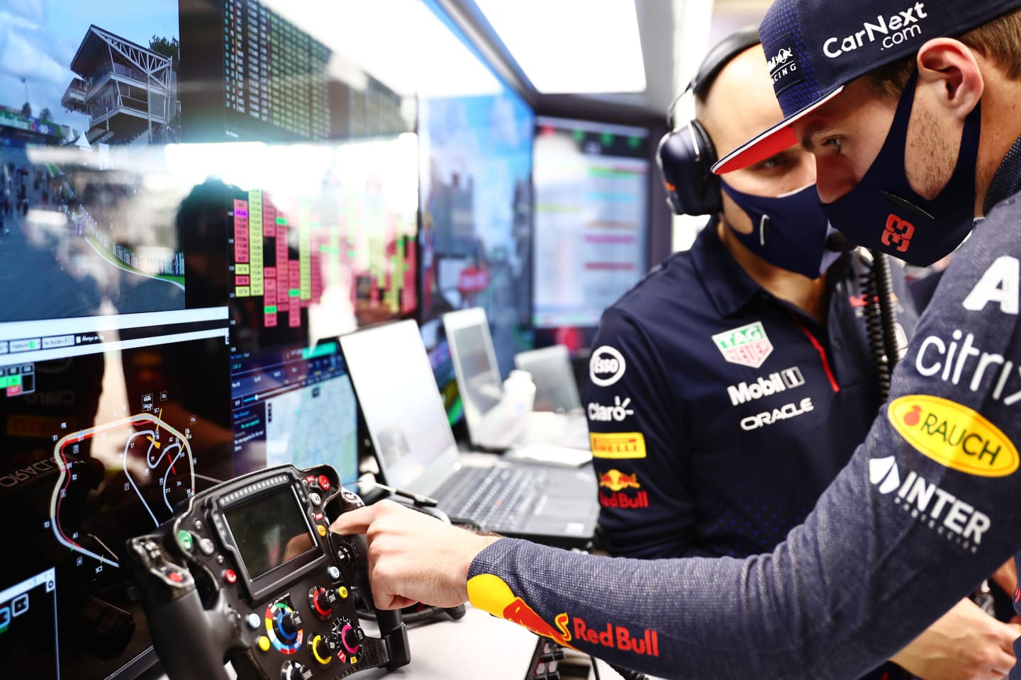 SAO PAULO, BRAZIL - NOVEMBER 13: Max Verstappen of Netherlands and Red Bull Racing talks with race engineer Gianpiero Lambiase in the garage before the sprint ahead of the F1 Grand Prix of Brazil at Autodromo Jose Carlos Pace on November 13, 2021 in Sao Paulo, Brazil. (Photo by Mark Thompson/Getty Images)