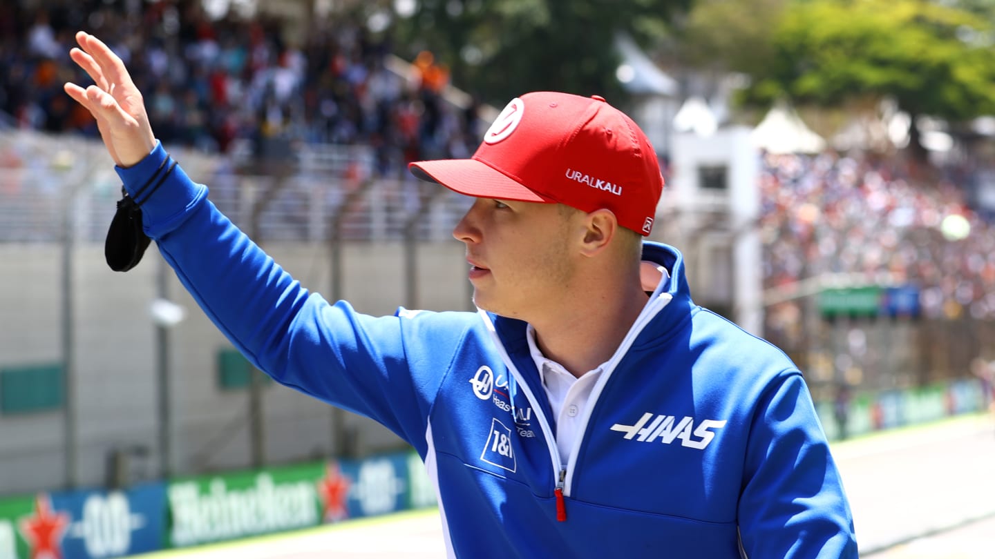 SAO PAULO, BRAZIL - NOVEMBER 14: Nikita Mazepin of Russia and Haas F1 waves to the crowd from the drivers parade before the F1 Grand Prix of Brazil at Autodromo Jose Carlos Pace on November 14, 2021 in Sao Paulo, Brazil. (Photo by Bryn Lennon - Formula 1/Formula 1 via Getty Images)