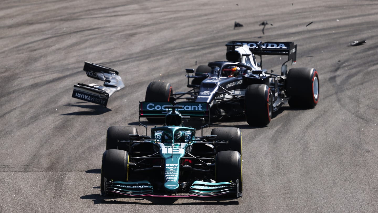 SAO PAULO, BRAZIL - NOVEMBER 14: Yuki Tsunoda of Japan driving the (22) Scuderia AlphaTauri AT02 Honda collides with Lance Stroll of Canada driving the (18) Aston Martin AMR21 Mercedes during the F1 Grand Prix of Brazil at Autodromo Jose Carlos Pace on November 14, 2021 in Sao Paulo, Brazil. (Photo by Bryn Lennon - Formula 1/Formula 1 via Getty Images)