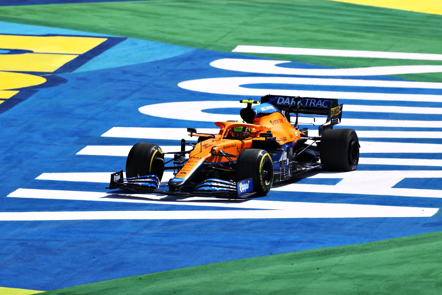 SAO PAULO, BRAZIL - NOVEMBER 14: Lando Norris of Great Britain driving the (4) McLaren F1 Team MCL35M Mercedes runs wide during the F1 Grand Prix of Brazil at Autodromo Jose Carlos Pace on November 14, 2021 in Sao Paulo, Brazil. (Photo by Bryn Lennon - Formula 1/Formula 1 via Getty Images)