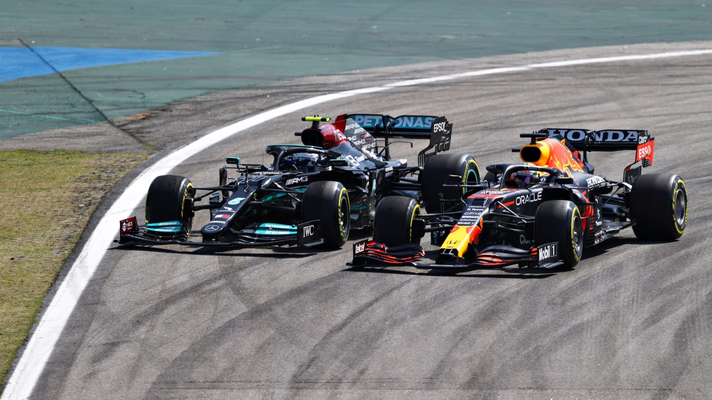 SAO PAULO, BRAZIL - NOVEMBER 14: Valtteri Bottas of Finland driving the (77) Mercedes AMG Petronas F1 Team Mercedes W12 and Max Verstappen of the Netherlands driving the (33) Red Bull Racing RB16B Honda compete for position on track at the start of the race during the F1 Grand Prix of Brazil at Autodromo Jose Carlos Pace on November 14, 2021 in Sao Paulo, Brazil. (Photo by Bryn Lennon - Formula 1/Formula 1 via Getty Images)