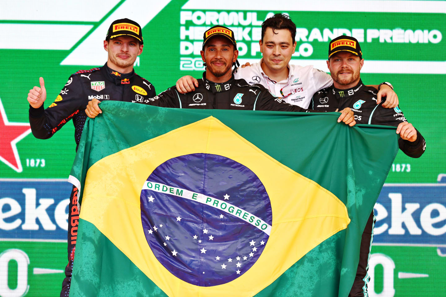 SAO PAULO, BRAZIL - NOVEMBER 14: Race winner Lewis Hamilton of Great Britain and Mercedes GP, second placed Max Verstappen of Netherlands and Red Bull Racing and third placed Valtteri Bottas of Finland and Mercedes GP celebrate on the podium during the F1 Grand Prix of Brazil at Autodromo Jose Carlos Pace on November 14, 2021 in Sao Paulo, Brazil. (Photo by Mark Thompson/Getty Images)