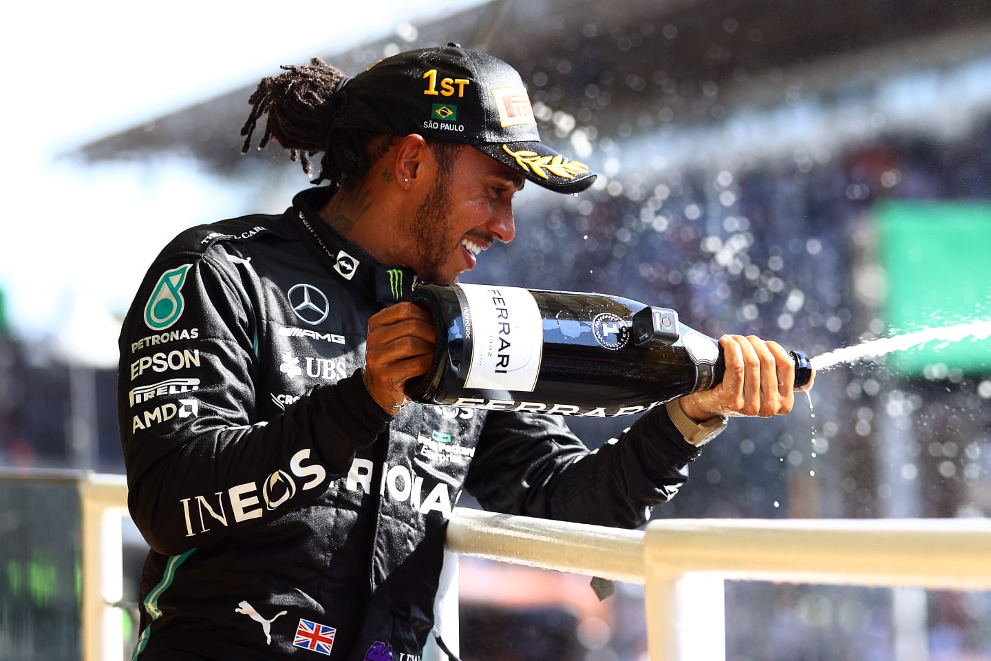 SAO PAULO, BRAZIL - NOVEMBER 14: Race winner Lewis Hamilton of Great Britain and Mercedes GP celebrates on the podium with sparkling wine during the F1 Grand Prix of Brazil at Autodromo Jose Carlos Pace on November 14, 2021 in Sao Paulo, Brazil. (Photo by Bryn Lennon - Formula 1/Formula 1 via Getty Images)
