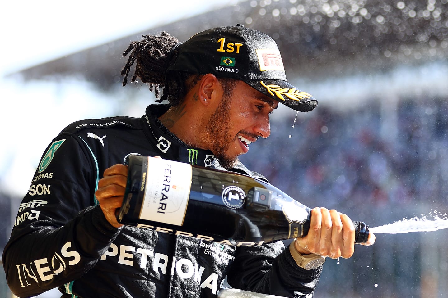 SAO PAULO, BRAZIL - NOVEMBER 14: Race winner Lewis Hamilton of Great Britain and Mercedes GP celebrates on the podium with sparkling wine during the F1 Grand Prix of Brazil at Autodromo Jose Carlos Pace on November 14, 2021 in Sao Paulo, Brazil. (Photo by Bryn Lennon - Formula 1/Formula 1 via Getty Images)