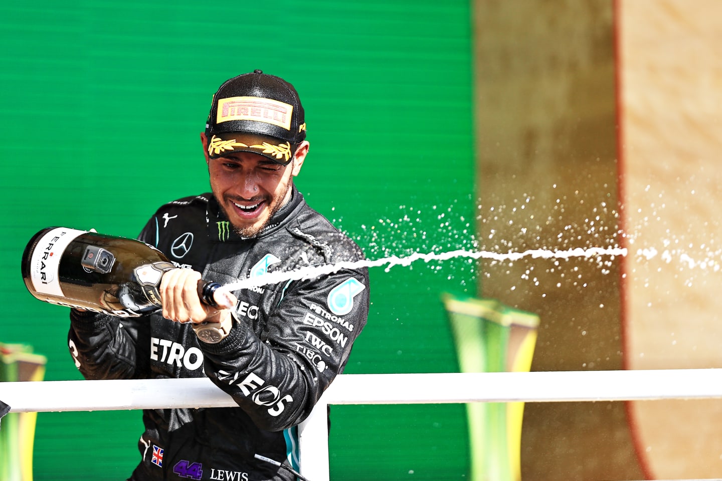 SAO PAULO, BRAZIL - NOVEMBER 14: Race winner Lewis Hamilton of Great Britain and Mercedes GP celebrates on the podium with sparkling wine during the F1 Grand Prix of Brazil at Autodromo Jose Carlos Pace on November 14, 2021 in Sao Paulo, Brazil. (Photo by Buda Mendes/Getty Images)