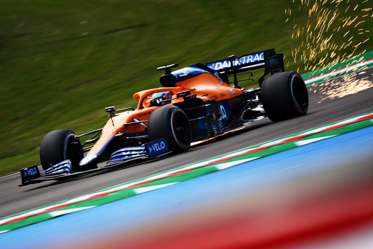 IMOLA, ITALY - APRIL 16: Sparks fly from the car of Daniel Ricciardo of Australia driving the (3) McLaren F1 Team MCL35M Mercedes during practice ahead of the F1 Grand Prix of Emilia Romagna at Autodromo Enzo e Dino Ferrari on April 16, 2021 in Imola, Italy. (Photo by Clive Mason - Formula 1/Formula 1 via Getty Images)