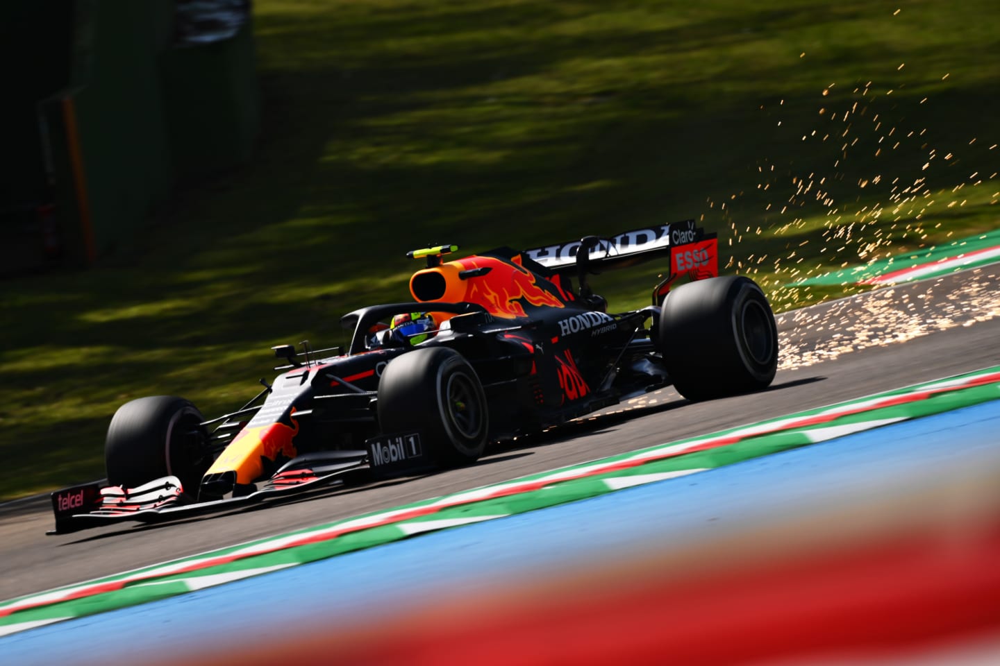 IMOLA, ITALY - APRIL 16: Sparks fly behind Sergio Perez of Mexico driving the (11) Red Bull Racing RB16B Honda during practice ahead of the F1 Grand Prix of Emilia Romagna at Autodromo Enzo e Dino Ferrari on April 16, 2021 in Imola, Italy. (Photo by Clive Mason - Formula 1/Formula 1 via Getty Images)