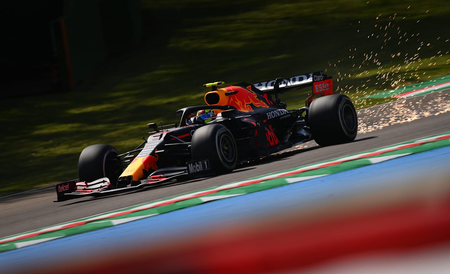 IMOLA, ITALY - APRIL 16: Sparks fly behind Sergio Perez of Mexico driving the (11) Red Bull Racing