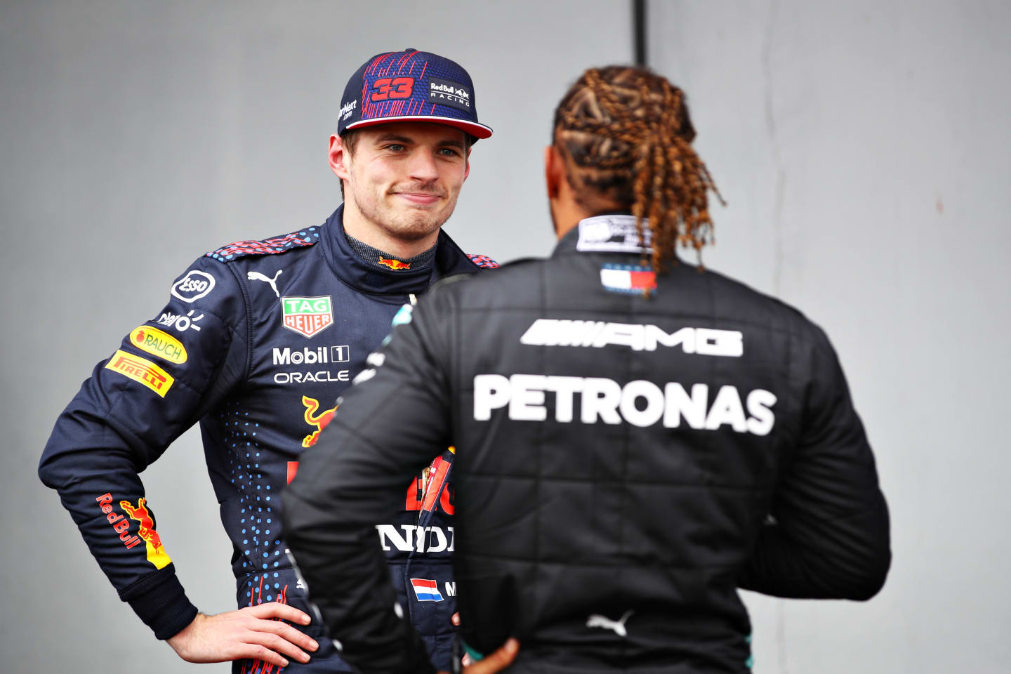 IMOLA, ITALY - APRIL 17: Third place qualifier Max Verstappen of Netherlands and Red Bull Racing talks with pole position qualifier Lewis Hamilton of Great Britain and Mercedes GP in parc ferme during qualifying ahead of the F1 Grand Prix of Emilia Romagna at Autodromo Enzo e Dino Ferrari on April 17, 2021 in Imola, Italy. (Photo by Mark Thompson/Getty Images)