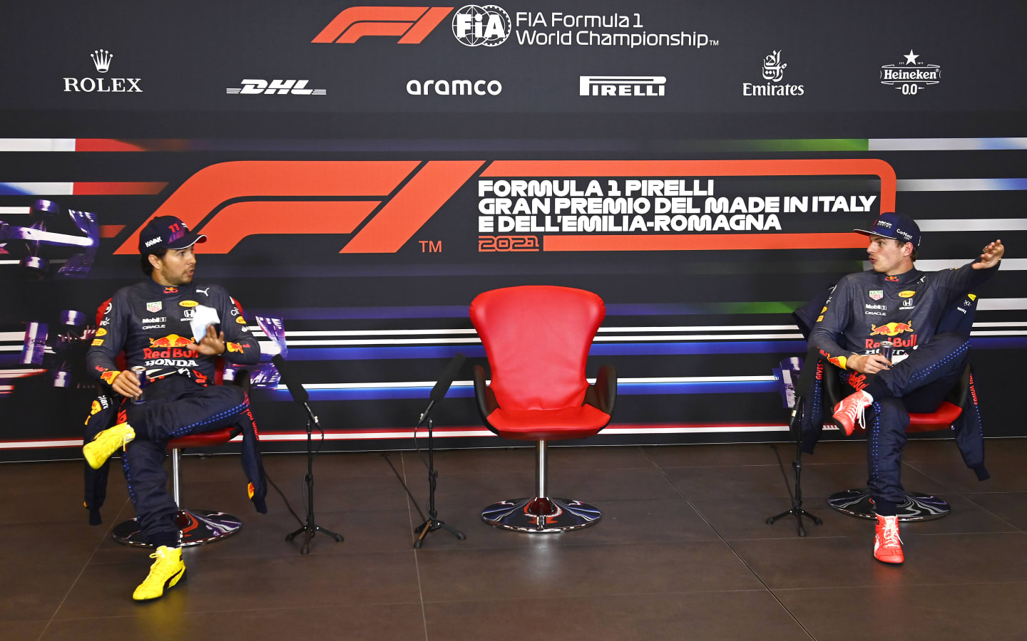 IMOLA, ITALY - APRIL 17:  Second place qualifier Sergio Perez of Mexico and Red Bull Racing and Third place qualifier Max Verstappen of Netherlands and Red Bull Racing wait for Pole position qualifier Lewis Hamilton of Great Britain and Mercedes GP during a press conference after qualifying ahead of the F1 Grand Prix of Emilia Romagna at Autodromo Enzo e Dino Ferrari on April 17, 2021 in Imola, Italy. (Photo by Mark Sutton - Pool/Getty Images)