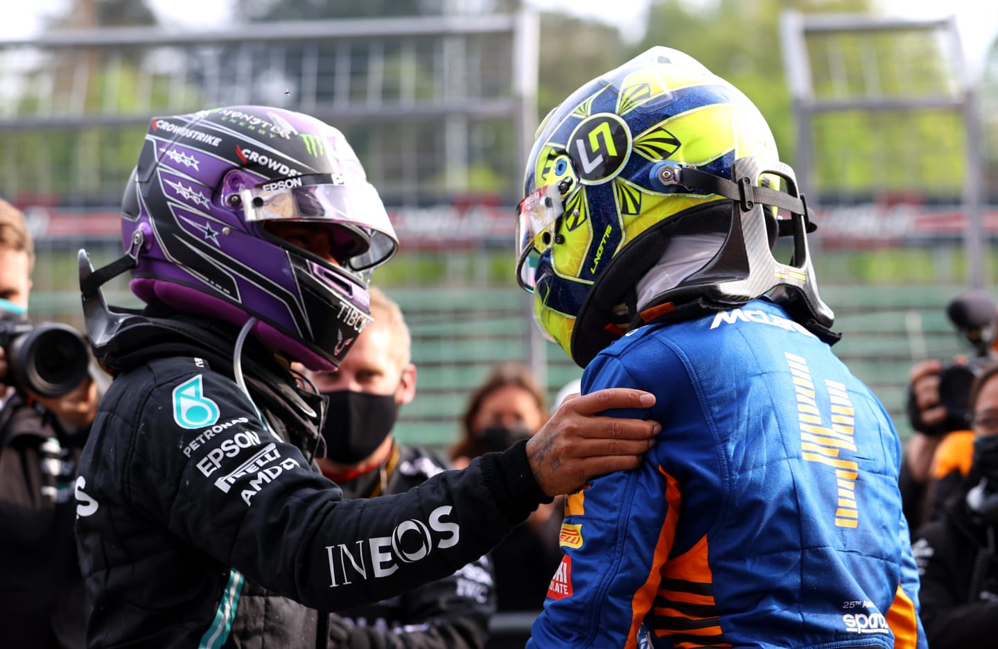 IMOLA, ITALY - APRIL 18: Second placed Lewis Hamilton of Great Britain and Mercedes GP and third placed Lando Norris of Great Britain and McLaren F1 hug in parc ferme during the F1 Grand Prix of Emilia Romagna at Autodromo Enzo e Dino Ferrari on April 18, 2021 in Imola, Italy. (Photo by Bryn Lennon/Getty Images)