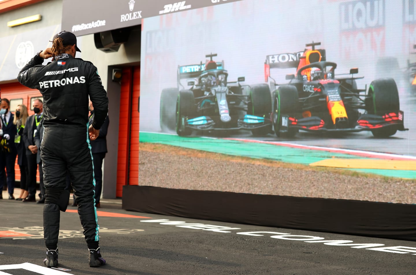 IMOLA, ITALY - APRIL 18: Second placed Lewis Hamilton of Great Britain and Mercedes GP watches a replay of the start of the race on a screen in parc ferme after the F1 Grand Prix of Emilia Romagna at Autodromo Enzo e Dino Ferrari on April 18, 2021 in Imola, Italy. (Photo by Bryn Lennon/Getty Images)