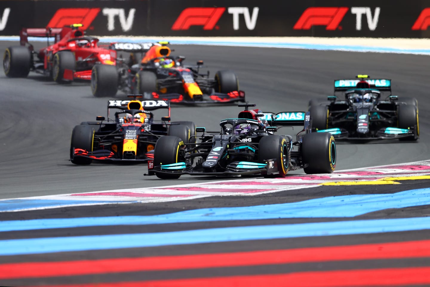 LE CASTELLET, FRANCE - JUNE 20: Lewis Hamilton of Great Britain driving the (44) Mercedes AMG Petronas F1 Team Mercedes W12 leads Max Verstappen of the Netherlands driving the (33) Red Bull Racing RB16B Honda and the rest of the field at the start of the race during the F1 Grand Prix of France at Circuit Paul Ricard on June 20, 2021 in Le Castellet, France. (Photo by Dan Istitene - Formula 1/Formula 1 via Getty Images)