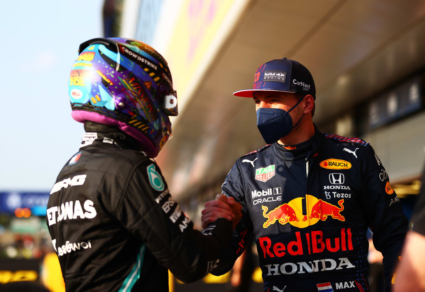 NORTHAMPTON, ENGLAND - JULY 16: Fastest qualifier Lewis Hamilton of Great Britain and Mercedes GP and second fastest qualifier Max Verstappen of Netherlands and Red Bull Racing shake hands in parc ferme during qualifying ahead of the F1 Grand Prix of Great Britain at Silverstone on July 16, 2021 in Northampton, England. (Photo by Dan Istitene - Formula 1/Formula 1 via Getty Images)