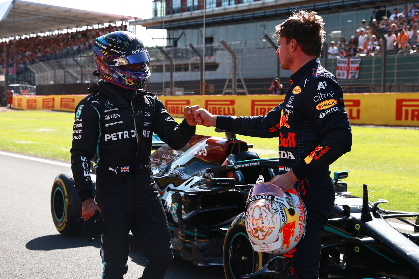 NORTHAMPTON, ENGLAND - JULY 17: Winner Max Verstappen of Netherlands and Red Bull Racing and second placed Lewis Hamilton of Great Britain and Mercedes GP bump fists in parc ferme during the Sprint for the F1 Grand Prix of Great Britain at Silverstone on July 17, 2021 in Northampton, England. (Photo by Mark Thompson/Getty Images)