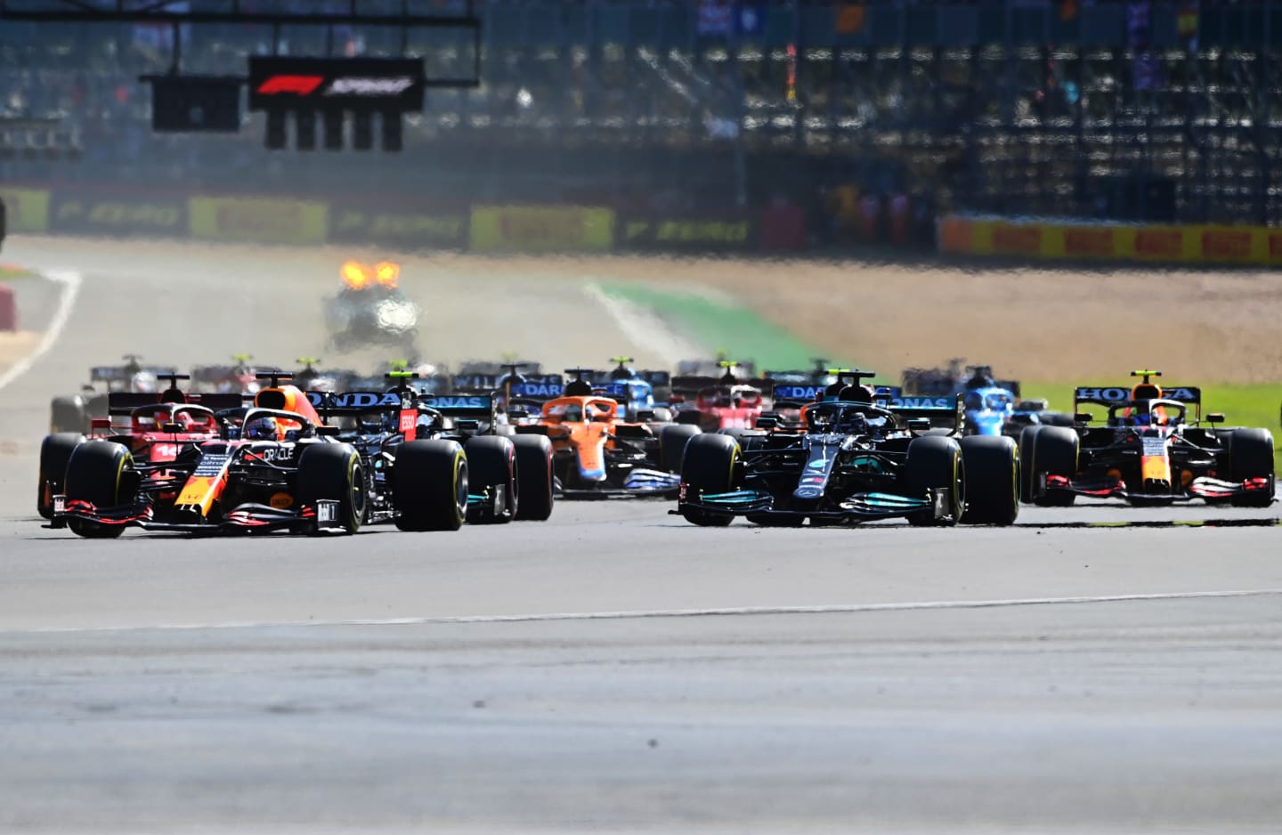 NORTHAMPTON, ENGLAND - JULY 17: Max Verstappen of the Netherlands driving the (33) Red Bull Racing RB16B Honda leads the field into turn one at the start during the Sprint for the F1 Grand Prix of Great Britain at Silverstone on July 17, 2021 in Northampton, England. (Photo by Michael Regan/Getty Images)