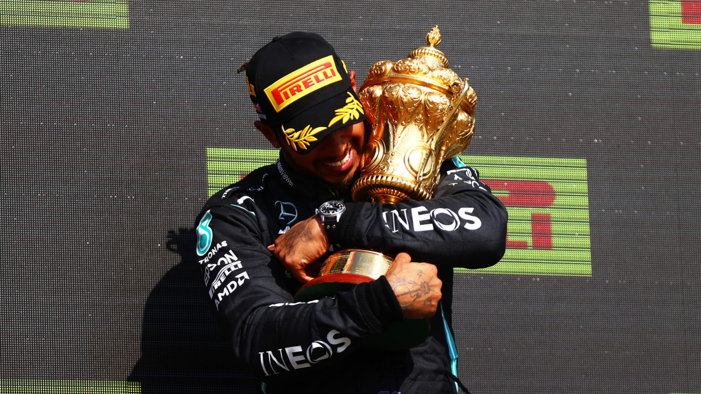 NORTHAMPTON, ENGLAND - JULY 18: Race winner Lewis Hamilton of Great Britain and Mercedes GP celebrates on the podium during the F1 Grand Prix of Great Britain at Silverstone on July 18, 2021 in Northampton, England. (Photo by Dan Istitene - Formula 1/Formula 1 via Getty Images)