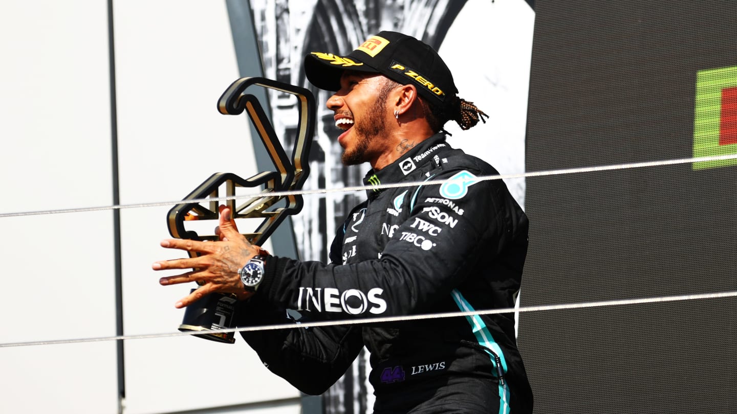 NORTHAMPTON, ENGLAND - JULY 18: Race winner Lewis Hamilton of Great Britain and Mercedes GP celebrates on the podium during the F1 Grand Prix of Great Britain at Silverstone on July 18, 2021 in Northampton, England. (Photo by Bryn Lennon - Formula 1/Formula 1 via Getty Images)