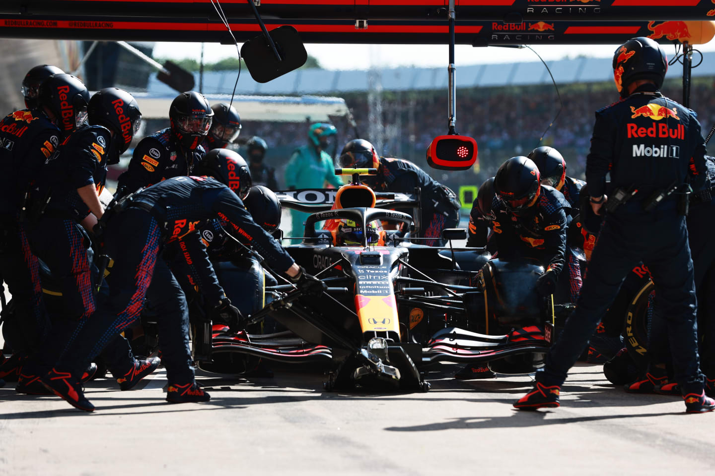 NORTHAMPTON, ENGLAND - JULY 18: Sergio Perez of Mexico driving the (11) Red Bull Racing RB16B Honda makes a pitstop during the F1 Grand Prix of Great Britain at Silverstone on July 18, 2021 in Northampton, England. (Photo by Mark Thompson/Getty Images)