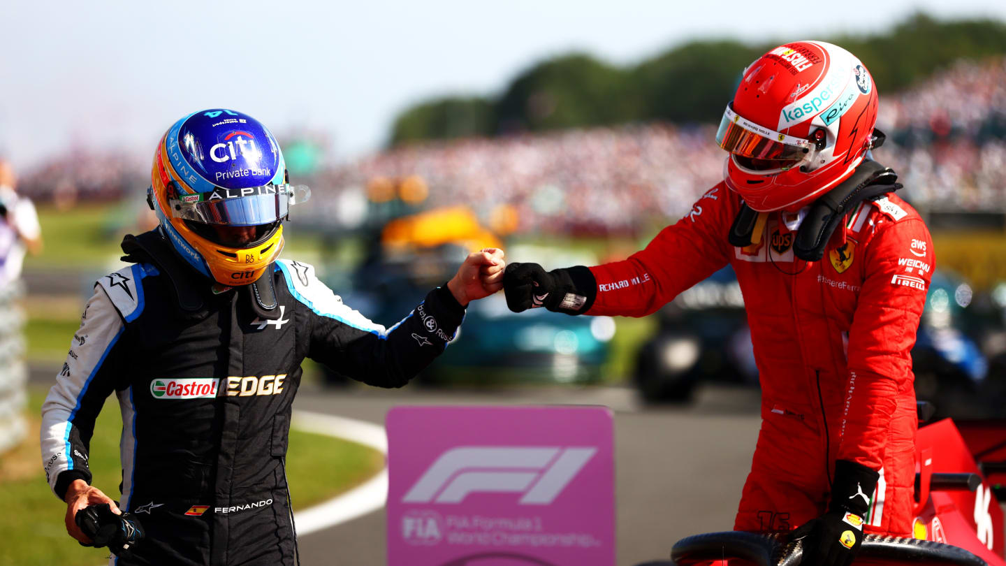 NORTHAMPTON, ENGLAND - JULY 18: Second placed Charles Leclerc of Monaco and Ferrari is congratulated by Fernando Alonso of Spain and Alpine F1 Team in parc ferme during the F1 Grand Prix of Great Britain at Silverstone on July 18, 2021 in Northampton, England. (Photo by Dan Istitene - Formula 1/Formula 1 via Getty Images)
