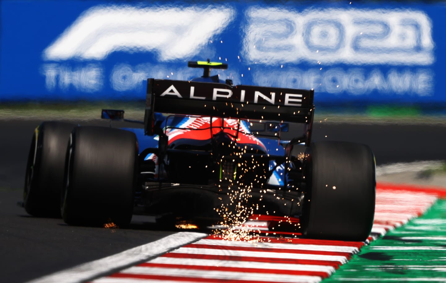BUDAPEST, HUNGARY - JULY 30: Sparks fly behind Esteban Ocon of France driving the (31) Alpine A521 Renault during practice ahead of the F1 Grand Prix of Hungary at Hungaroring on July 30, 2021 in Budapest, Hungary. (Photo by Bryn Lennon/Getty Images)