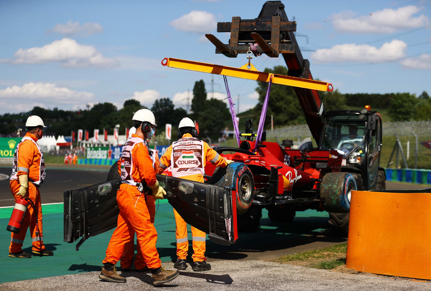 BUDAPEST, HUNGARY - JULY 31: The car of Carlos Sainz of Spain and Ferrari is removed from the track after a crash during qualifying ahead of the F1 Grand Prix of Hungary at Hungaroring on July 31, 2021 in Budapest, Hungary. (Photo by Bryn Lennon/Getty Images)
