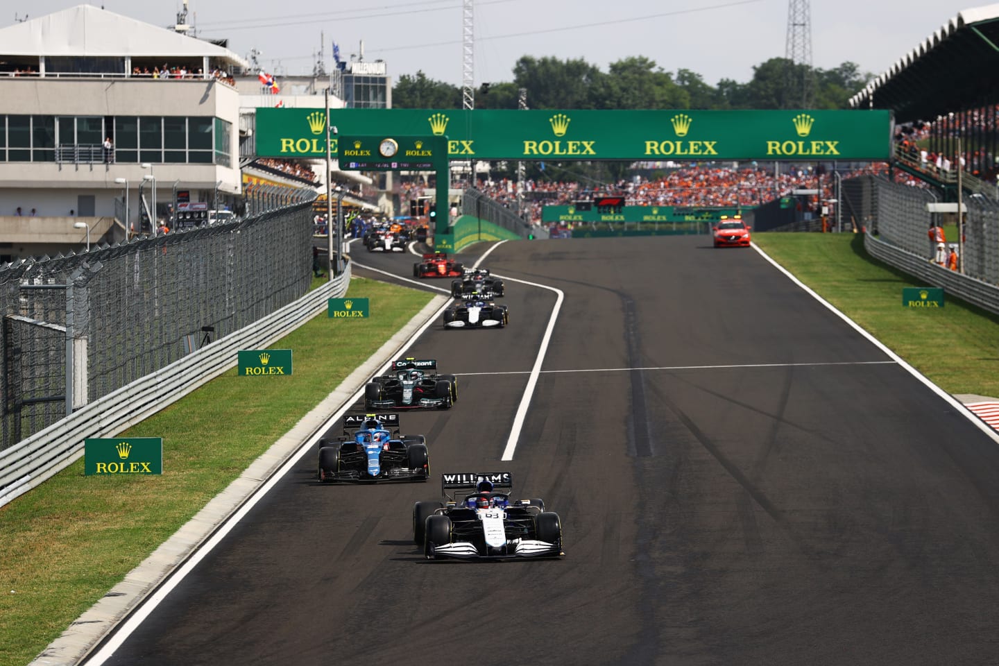 BUDAPEST, HUNGARY - AUGUST 01: George Russell of Great Britain driving the (63) Williams Racing FW43B Mercedes leads a line of cars out of the pitlane after pitting at the restart during the F1 Grand Prix of Hungary at Hungaroring on August 01, 2021 in Budapest, Hungary. (Photo by Bryn Lennon/Getty Images)