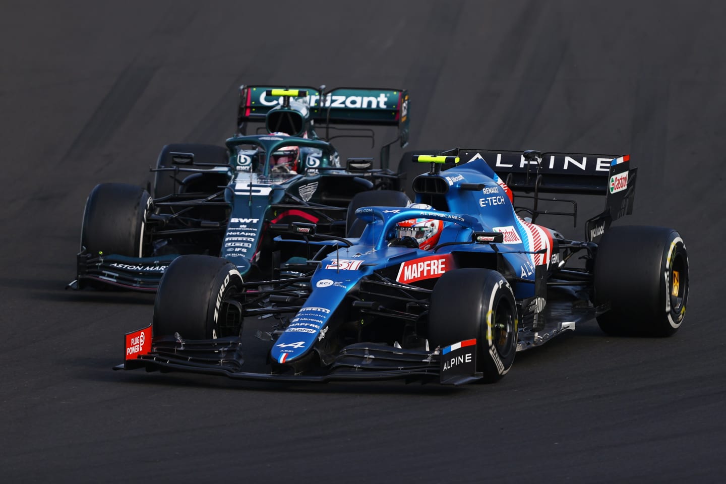 BUDAPEST, HUNGARY - AUGUST 01: Esteban Ocon of France driving the (31) Alpine A521 Renault leads Sebastian Vettel of Germany driving the (5) Aston Martin AMR21 Mercedes during the F1 Grand Prix of Hungary at Hungaroring on August 01, 2021 in Budapest, Hungary. (Photo by Bryn Lennon/Getty Images)