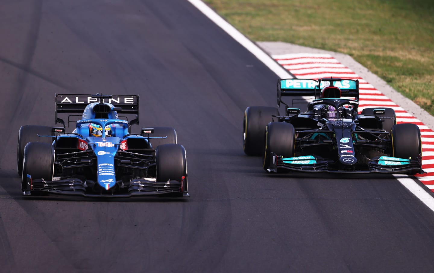 BUDAPEST, HUNGARY - AUGUST 01: Fernando Alonso of Spain driving the (14) Alpine A521 Renault defends from Lewis Hamilton of Great Britain driving the (44) Mercedes AMG Petronas F1 Team Mercedes W12 during the F1 Grand Prix of Hungary at Hungaroring on August 01, 2021 in Budapest, Hungary. (Photo by Lars Baron/Getty Images)