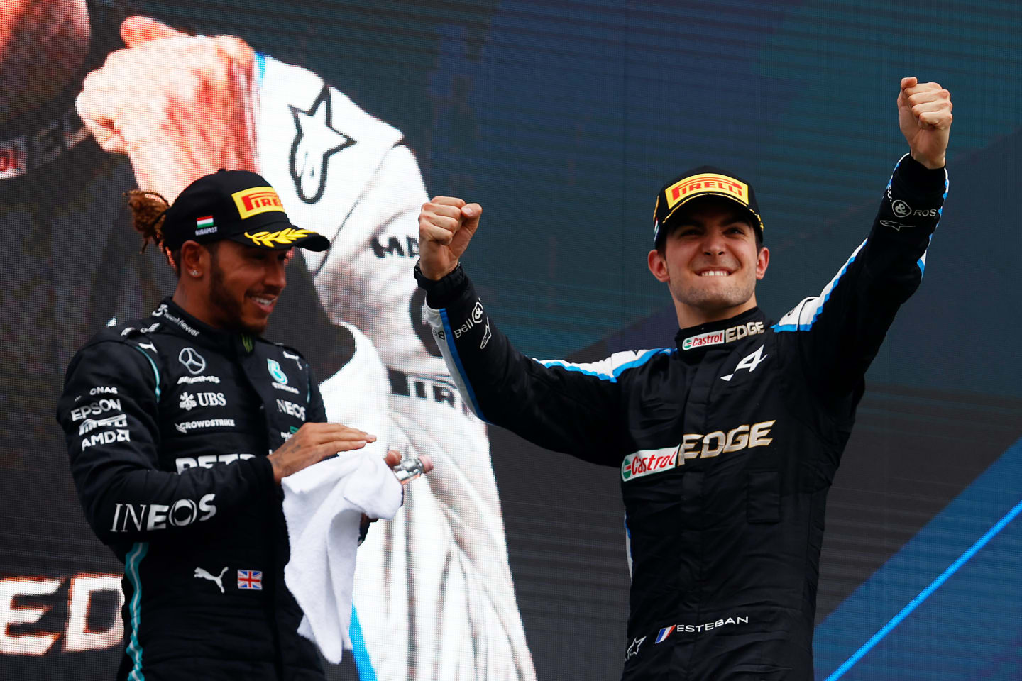 BUDAPEST, HUNGARY - AUGUST 01: Race winner Esteban Ocon of France and Alpine F1 Team celebrates on the podium next to third placed Lewis Hamilton of Great Britain and Mercedes GP during the F1 Grand Prix of Hungary at Hungaroring on August 01, 2021 in Budapest, Hungary. (Photo by Florion Goga - Pool/Getty Images)