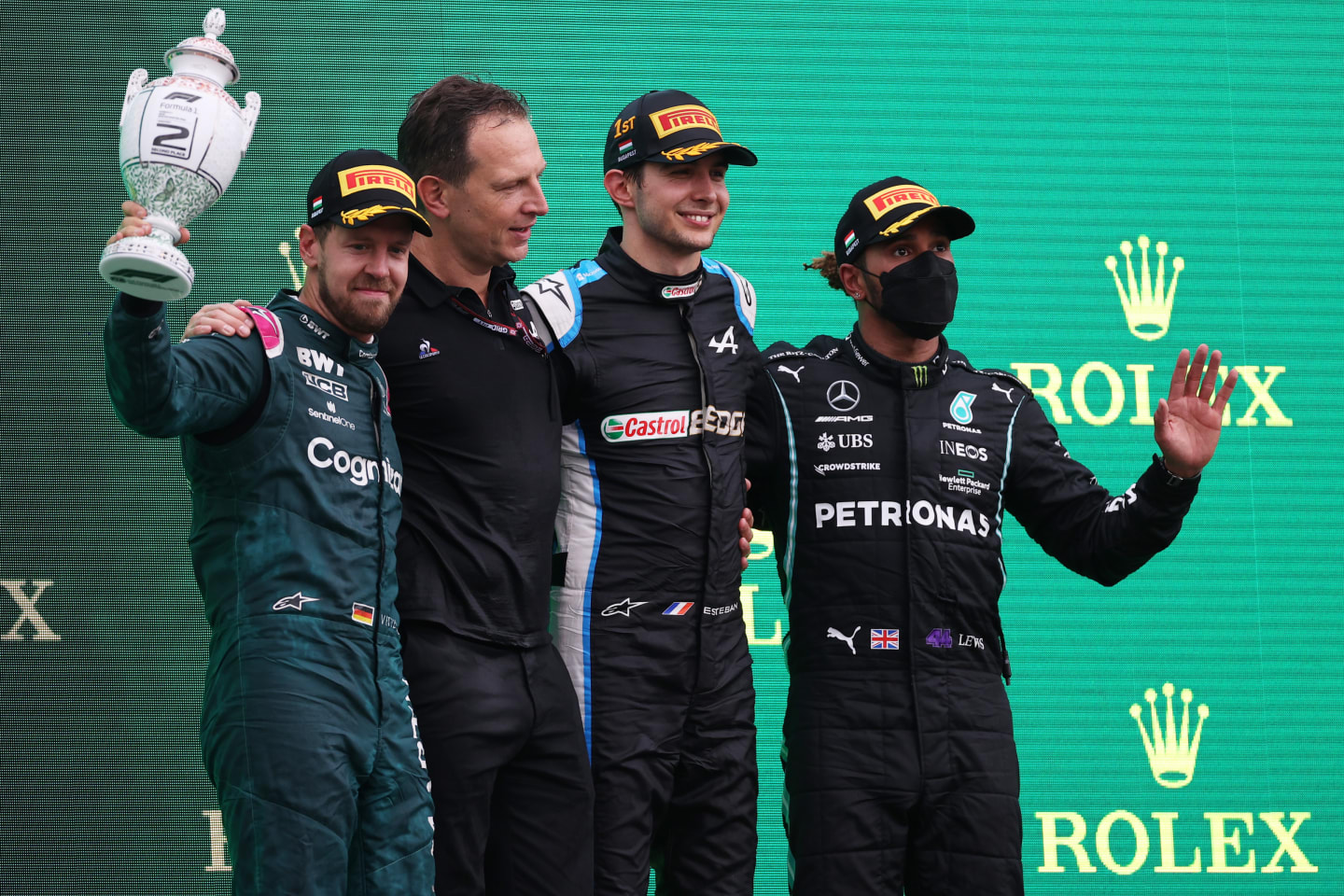 BUDAPEST, HUNGARY - AUGUST 01: Race winner Esteban Ocon of France and Alpine F1 Team, second placed Sebastian Vettel of Germany and Aston Martin F1 Team and third placed Lewis Hamilton of Great Britain and Mercedes GP celebrate on the podium during the F1 Grand Prix of Hungary at Hungaroring on August 01, 2021 in Budapest, Hungary. (Photo by Lars Baron/Getty Images)