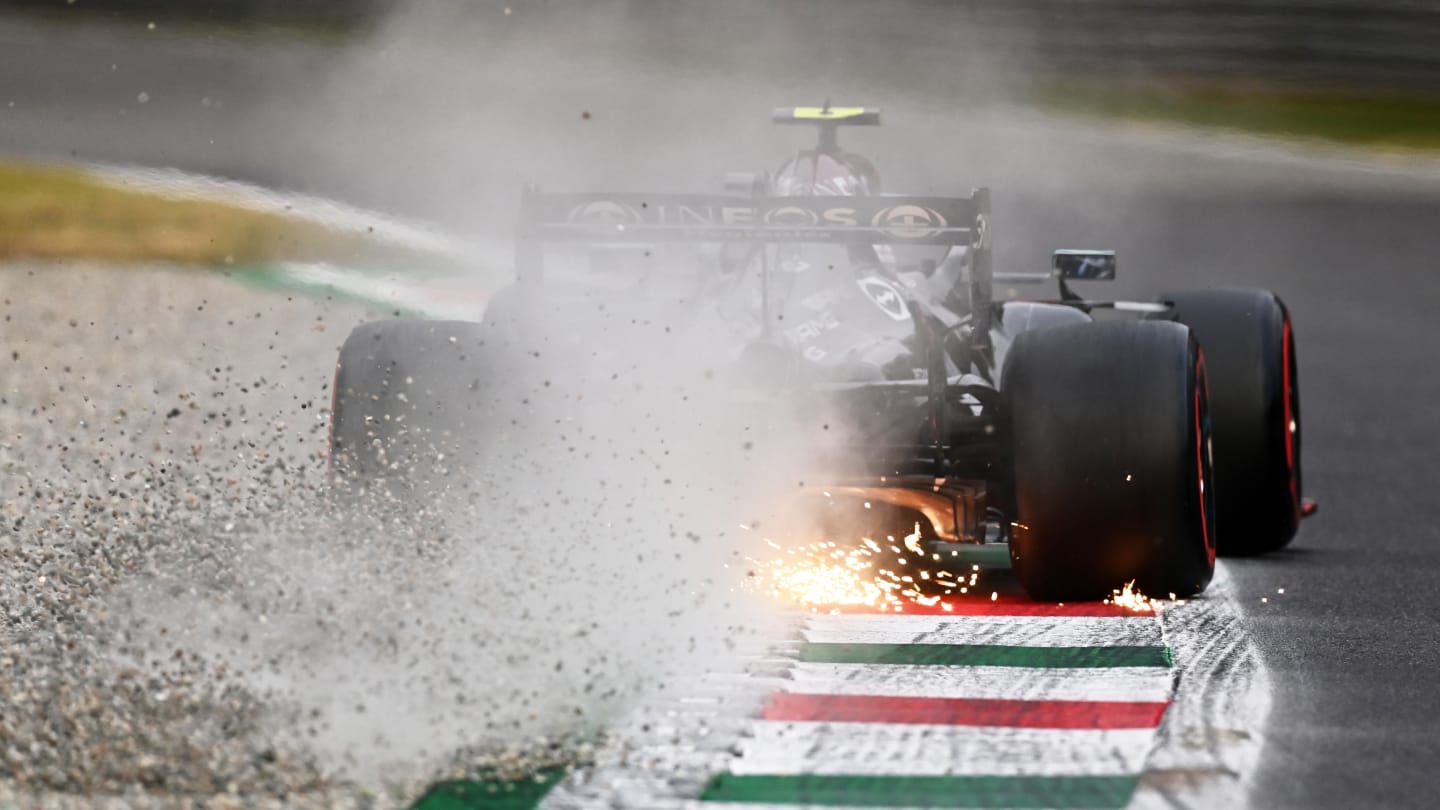 MONZA, ITALY - SEPTEMBER 10: Sparks and gravel fly behind Valtteri Bottas of Finland driving the (77) Mercedes AMG Petronas F1 Team Mercedes W12 during qualifying ahead of the F1 Grand Prix of Italy at Autodromo di Monza on September 10, 2021 in Monza, Italy. (Photo by Clive Mason - Formula 1/Formula 1 via Getty Images)
