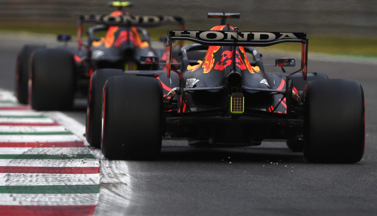 MONZA, ITALY - SEPTEMBER 10: Max Verstappen of the Netherlands driving the (33) Red Bull Racing RB16B Honda and Sergio Perez of Mexico driving the (11) Red Bull Racing RB16B Honda during qualifying ahead of the F1 Grand Prix of Italy at Autodromo di Monza on September 10, 2021 in Monza, Italy. (Photo by Rudy Carezzevoli/Getty Images)