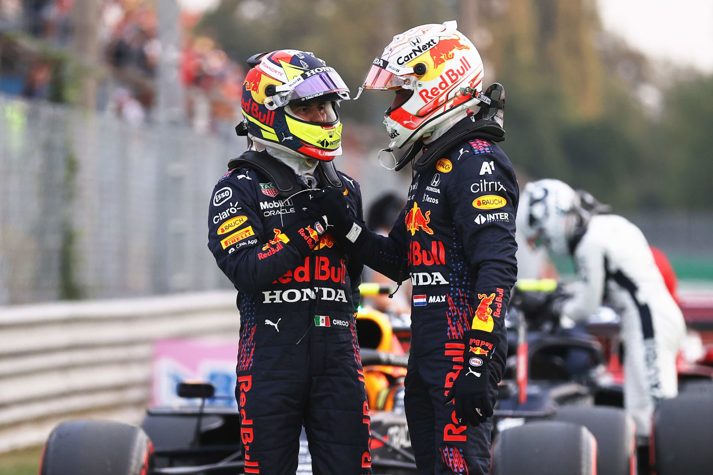MONZA, ITALY - SEPTEMBER 10: Max Verstappen of Netherlands and Red Bull Racing and Sergio Perez of Mexico and Red Bull Racing talk in parc ferme during qualifying ahead of the F1 Grand Prix of Italy at Autodromo di Monza on September 10, 2021 in Monza, Italy. (Photo by Lars Baron/Getty Images)