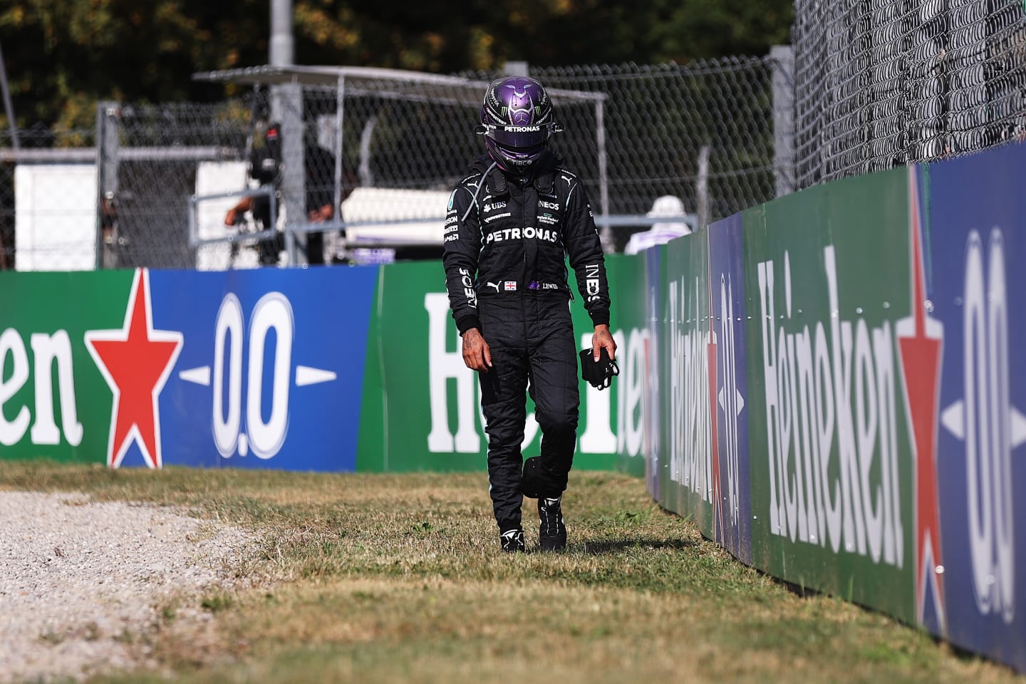MONZA, ITALY - SEPTEMBER 12: Lewis Hamilton of Great Britain and Mercedes GP walks back to the pits after crashing during the F1 Grand Prix of Italy at Autodromo di Monza on September 12, 2021 in Monza, Italy. (Photo by Lars Baron/Getty Images)