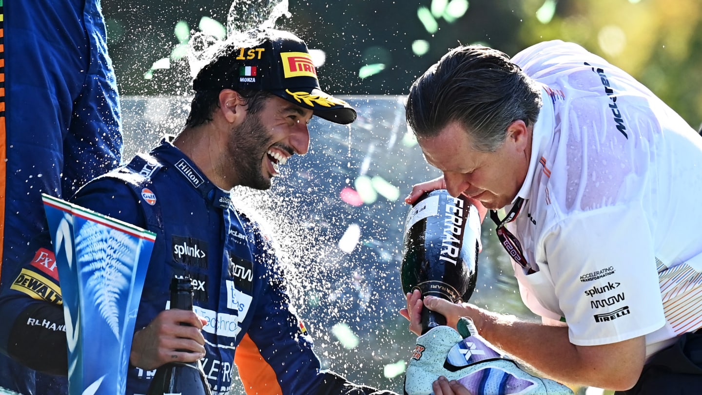 MONZA, ITALY - SEPTEMBER 12: Race winner Daniel Ricciardo of Australia and McLaren F1 and McLaren Chief Executive Officer Zak Brown celebrate on the podium during the F1 Grand Prix of Italy at Autodromo di Monza on September 12, 2021 in Monza, Italy. (Photo by Clive Mason - Formula 1/Formula 1 via Getty Images)