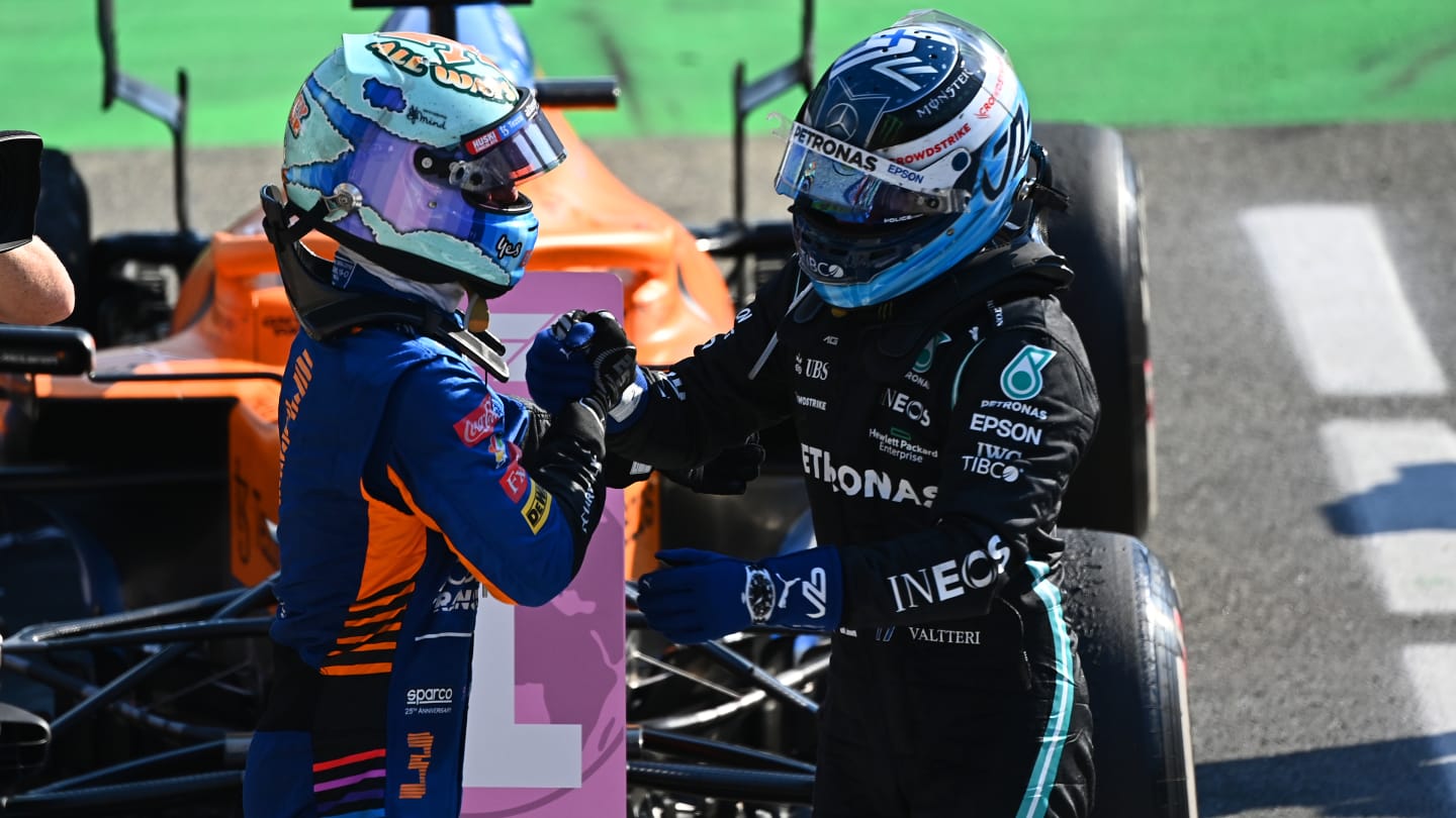 MONZA, ITALY - SEPTEMBER 12: Race winner Daniel Ricciardo of Australia and McLaren F1 and third placed Valtteri Bottas of Finland and Mercedes GP celebrate in parc ferme during the F1 Grand Prix of Italy at Autodromo di Monza on September 12, 2021 in Monza, Italy. (Photo by Clive Mason - Formula 1/Formula 1 via Getty Images)